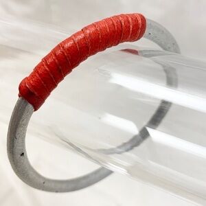 Silver metal bangle bracelet wrapped red leather